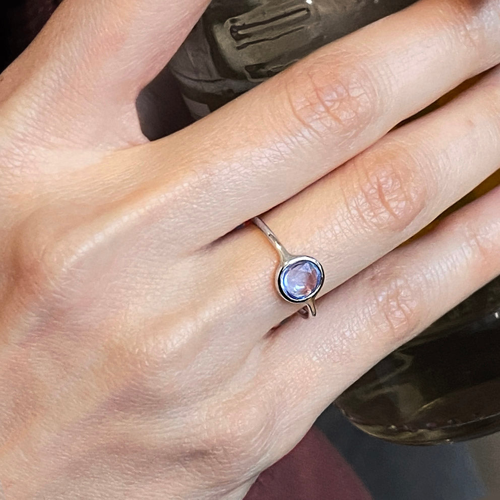 0.56ct blue sapphire ring in 18k white gold on finger