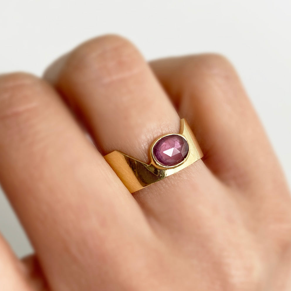 pink sapphire cigar ring 18k gold on finger