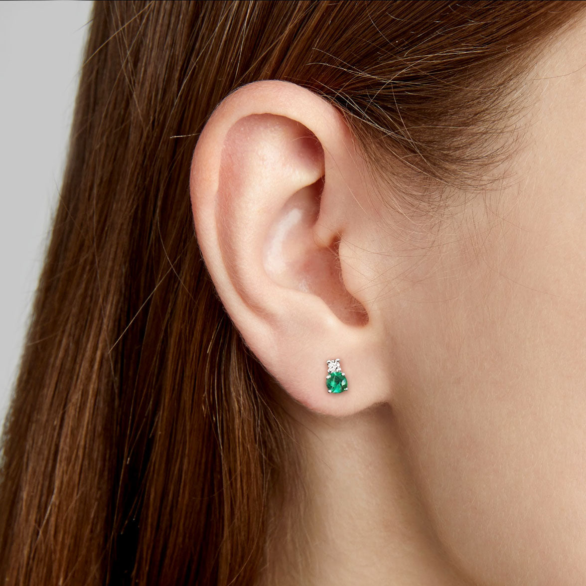 round emerald diamond earrings 18k white gold on ear