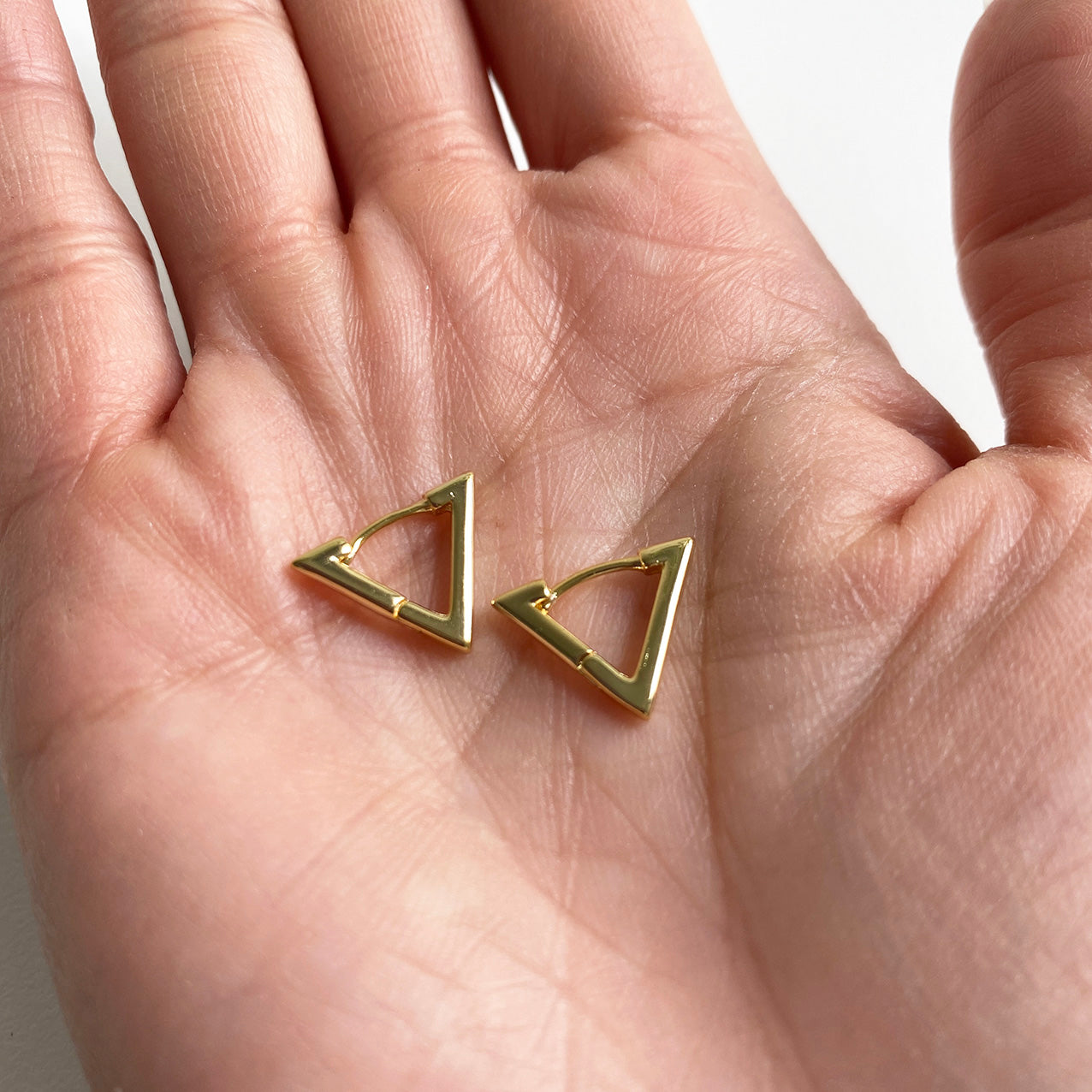 triangle earrings 18k gold plated sterling silver on hand